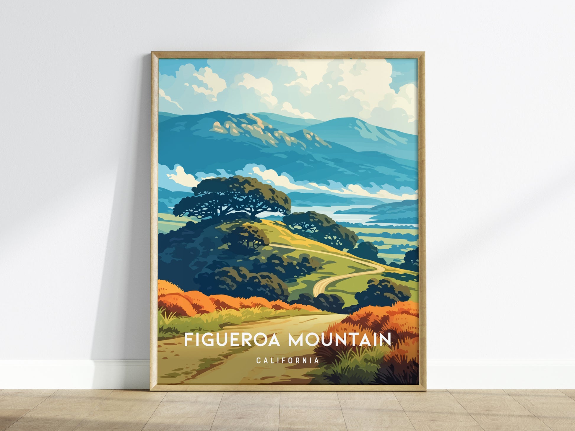 A framed poster of Figueroa Mountain in California showcases a vibrant landscape with rolling hills, lush greenery, and a backdrop of distant mountains under a bright blue sky.