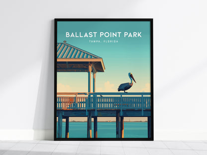 Framed poster of Ballast Point Park in Tampa, Florida, featuring a pelican perched on a pier against a serene coastal background with a gazebo and calm waters.