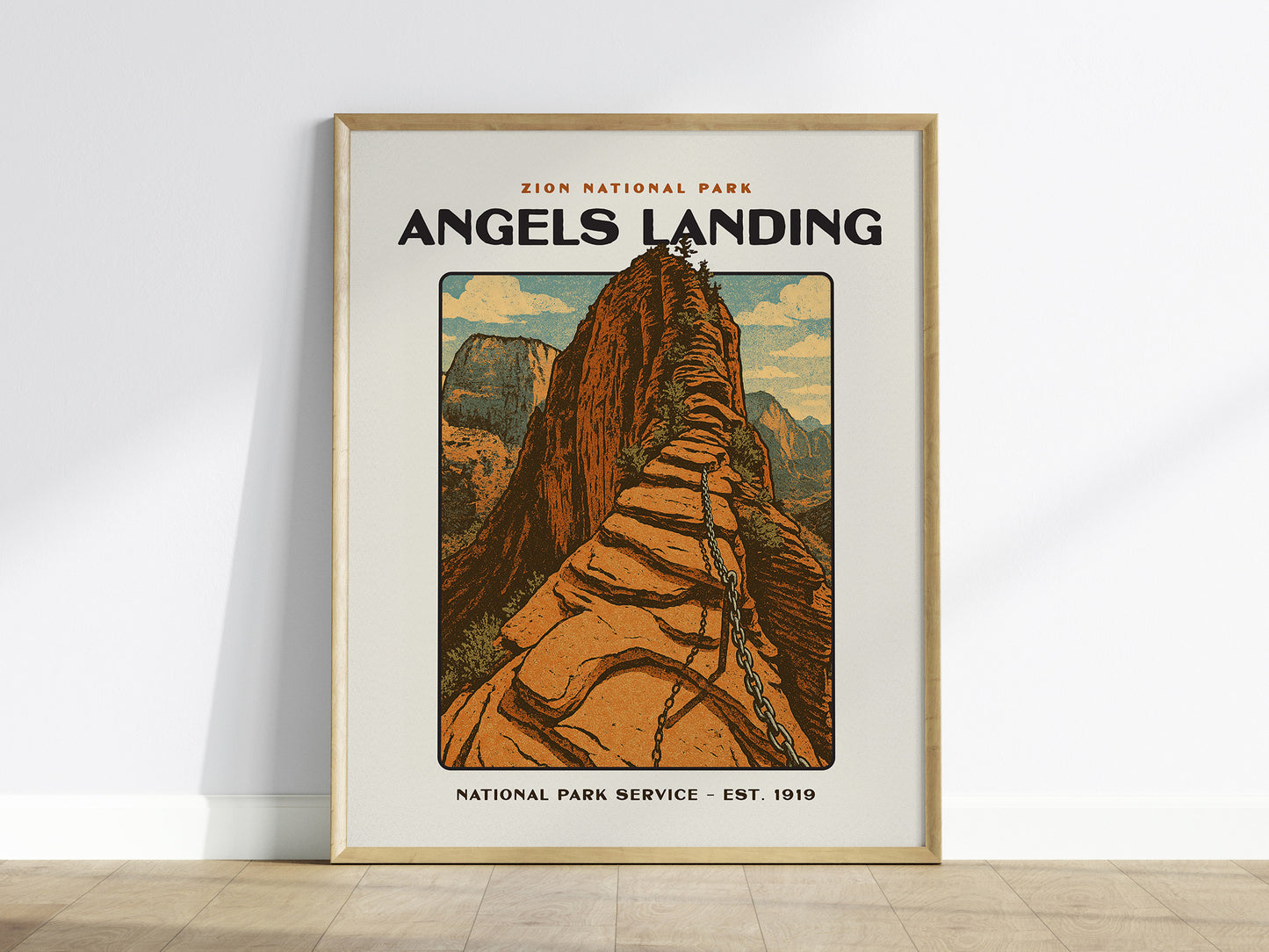 A framed poster of Angels Landing in Zion National Park features a vintage design with a steep sandstone path and canyon views. Text reads Zion National Park Angels Landing.