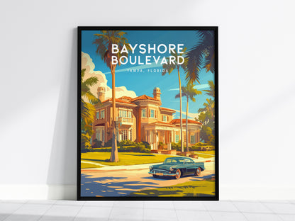 A framed poster depicts Bayshore Boulevard in Tampa, Florida, featuring a classic car driving past a grand historic house with palm trees under a clear blue sky.
