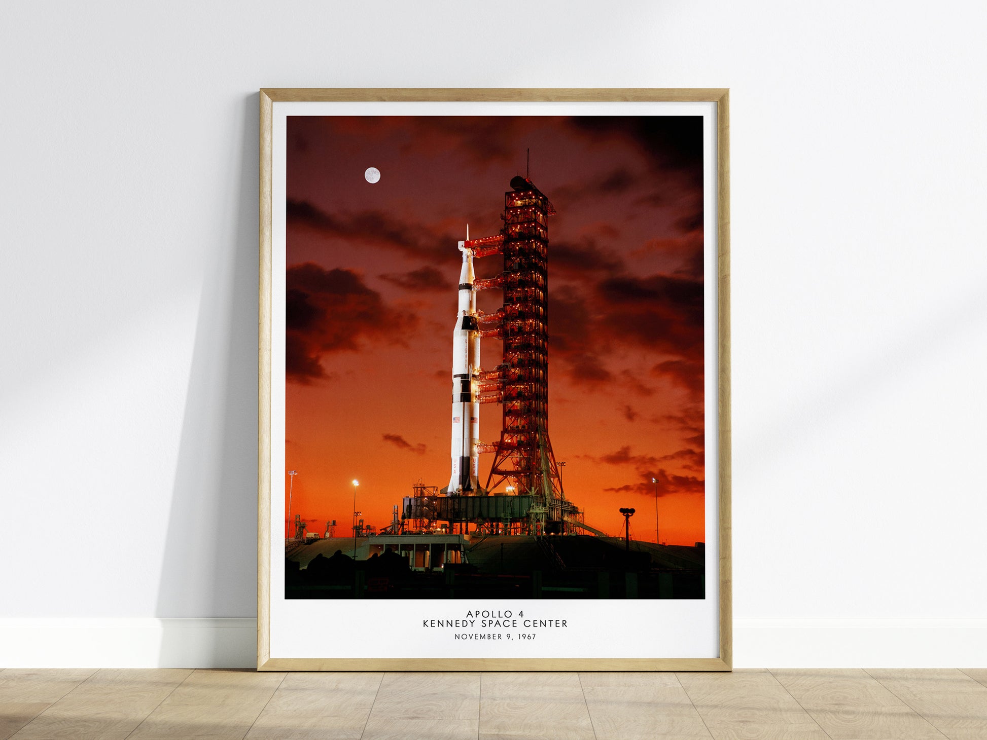 Framed Apollo 4 Saturn V launch wall art hanging on a white wall in a modern living room