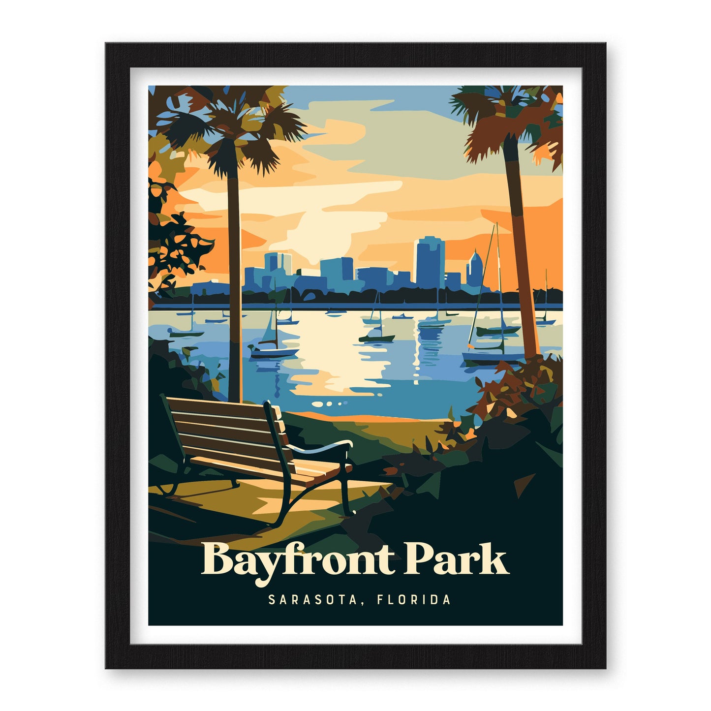 Framed artwork depicting Bayfront Park in Sarasota, Florida, features a serene scene with a bench facing a shimmering bay, sailboats, and a city skyline under a colorful sky. Palm trees frame the view.