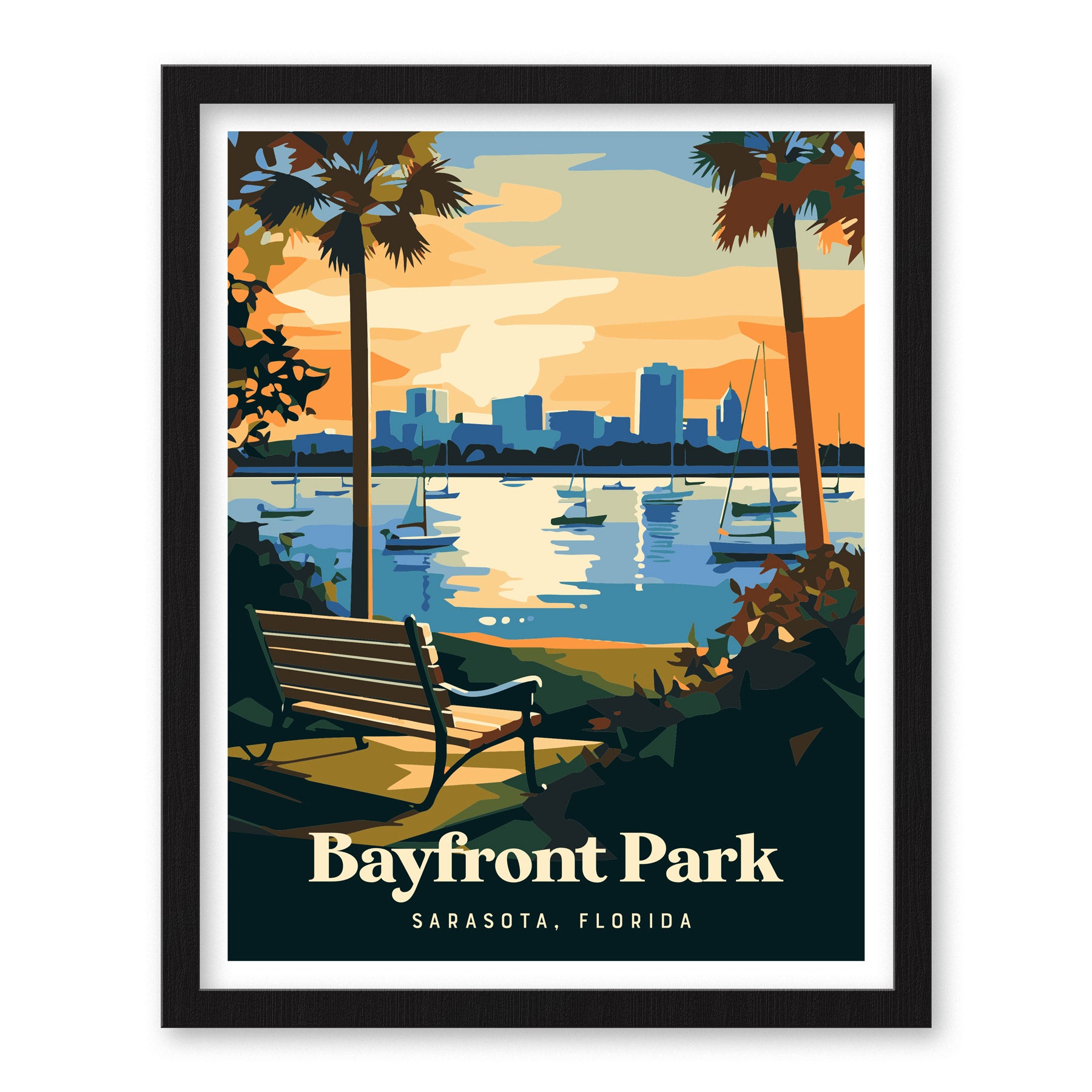 Framed artwork depicting Bayfront Park in Sarasota, Florida, features a serene scene with a bench facing a shimmering bay, sailboats, and a city skyline under a colorful sky. Palm trees frame the view.