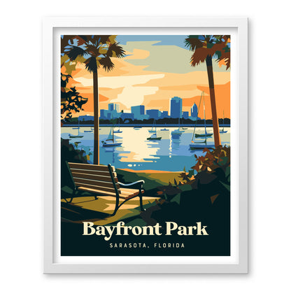 A stylized poster of Bayfront Park in Sarasota, Florida, featuring a bench overlooking calm waters with sailboats and a city skyline at sunset. Palm trees frame the scene, creating a tranquil coastal atmosphere.