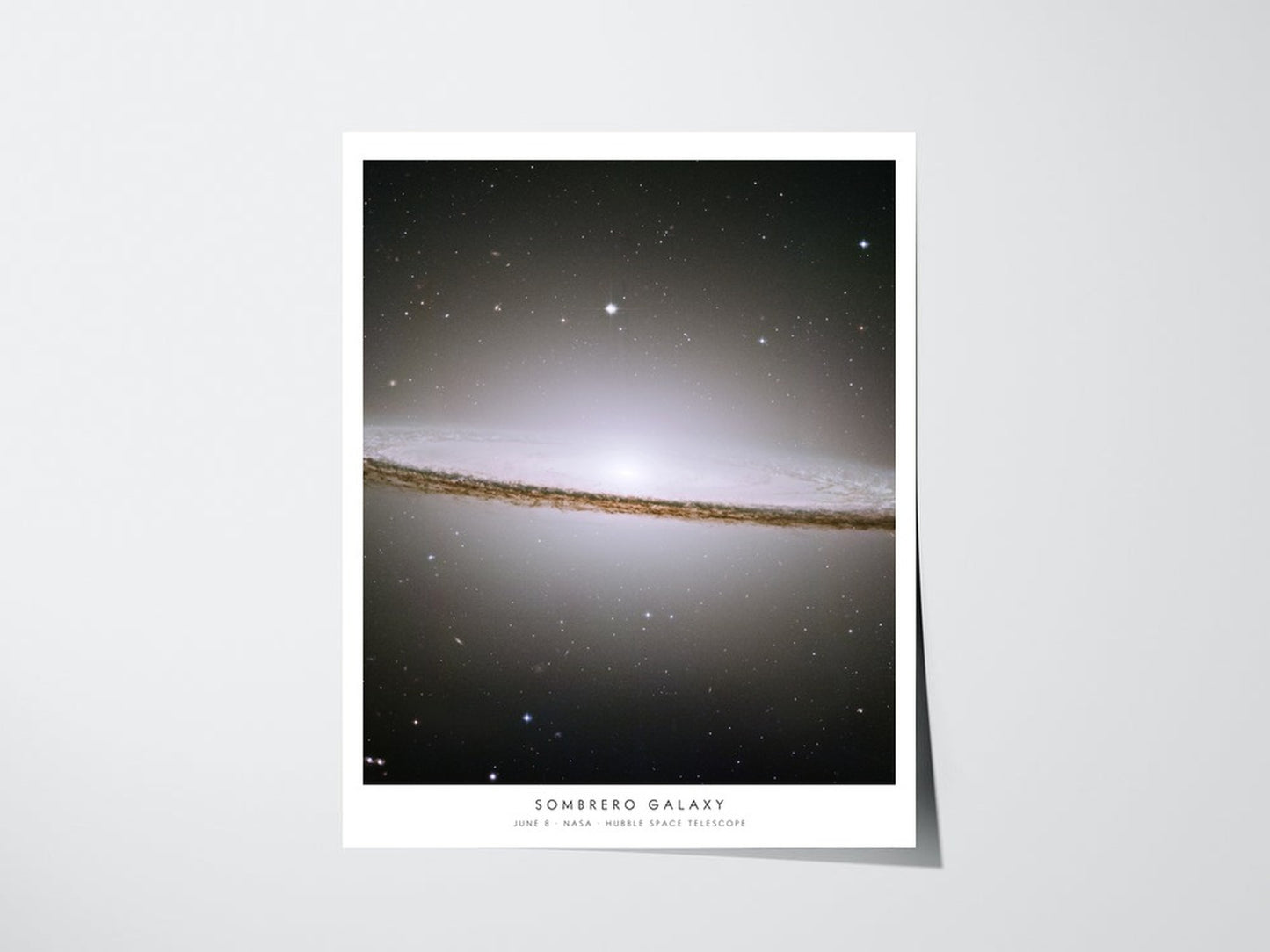 Personalized Hubble birthday print showing Sombrero Galaxy for June 8, unframed giclee poster with caption on a light wall
