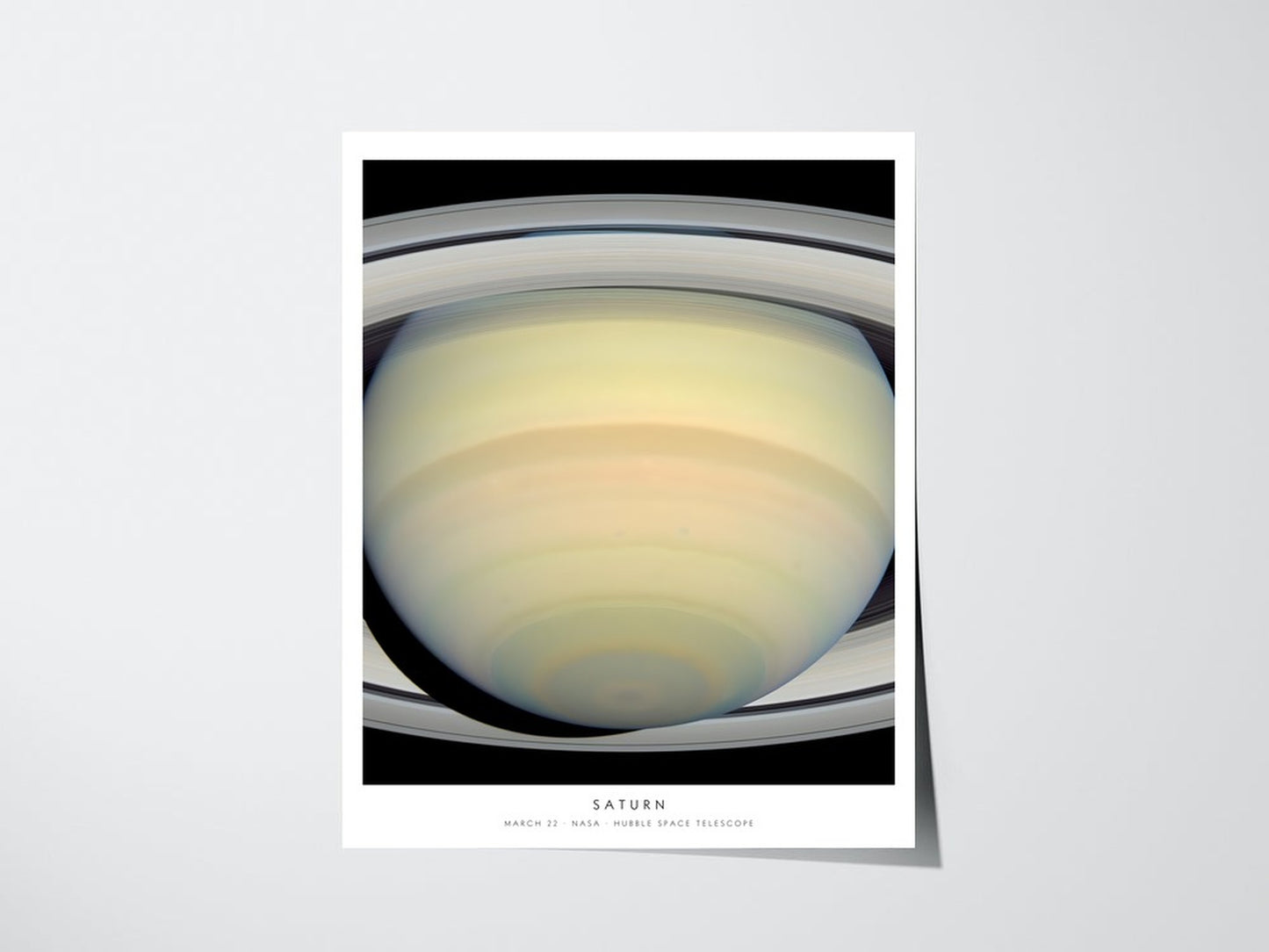 Personalized Hubble birthday print showing Saturn for March 22, unframed giclee poster with caption on a light wall