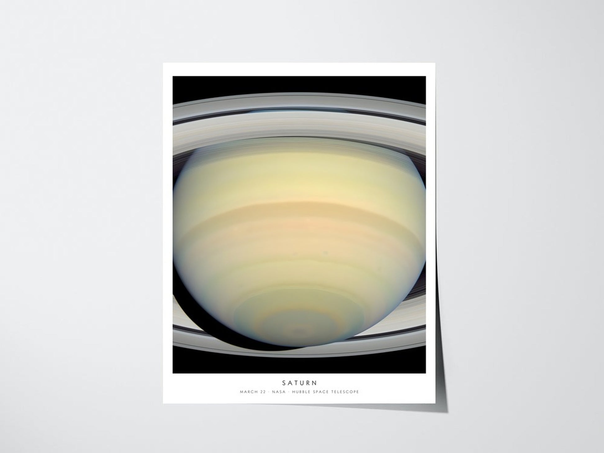 Personalized Hubble birthday print showing Saturn for March 22, unframed giclee poster with caption on a light wall
