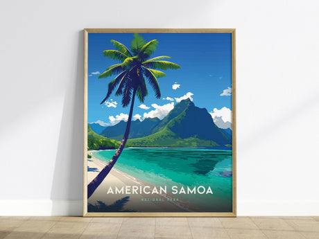 A framed poster of American Samoa features a vibrant illustration of Ofu Beach with a tall palm tree, turquoise waters, and lush green mountains under a clear blue sky. The text American Samoa National Park is displayed at the bottom.