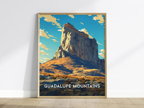 This framed poster features a stylized illustration of Guadalupe Mountains, showcasing a prominent peak under a vibrant blue sky with scattered clouds. The text Guadalupe Mountains National Park is displayed at the bottom.