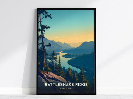 Framed poster depicting a scenic view of Rattlesnake Ridge in Washington, showcasing a sunset over lush forests and winding waterways. Tall pine trees frame the foreground, with mountains silhouetted against the colorful sky.