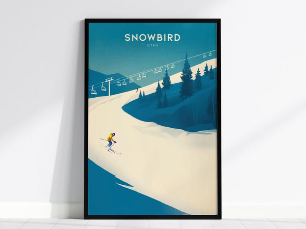 A framed poster displays a skier in a yellow outfit navigating a snowy slope under a clear blue sky, with pine trees and ski lifts in the background. The word Snowbird is prominently featured at the top.