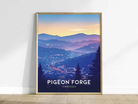 A framed poster depicting a scenic view of Pigeon Forge, Tennessee, with rolling mountains at dusk, a ferris wheel, and a winding road. The sky is a gradient of soft orange and blue, creating a tranquil atmosphere.