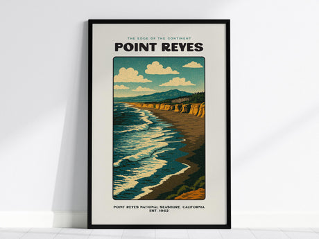 This image shows a framed vintage-style poster of Point Reyes, featuring a coastline with ocean waves, cliffs, and a clear sky with clouds.