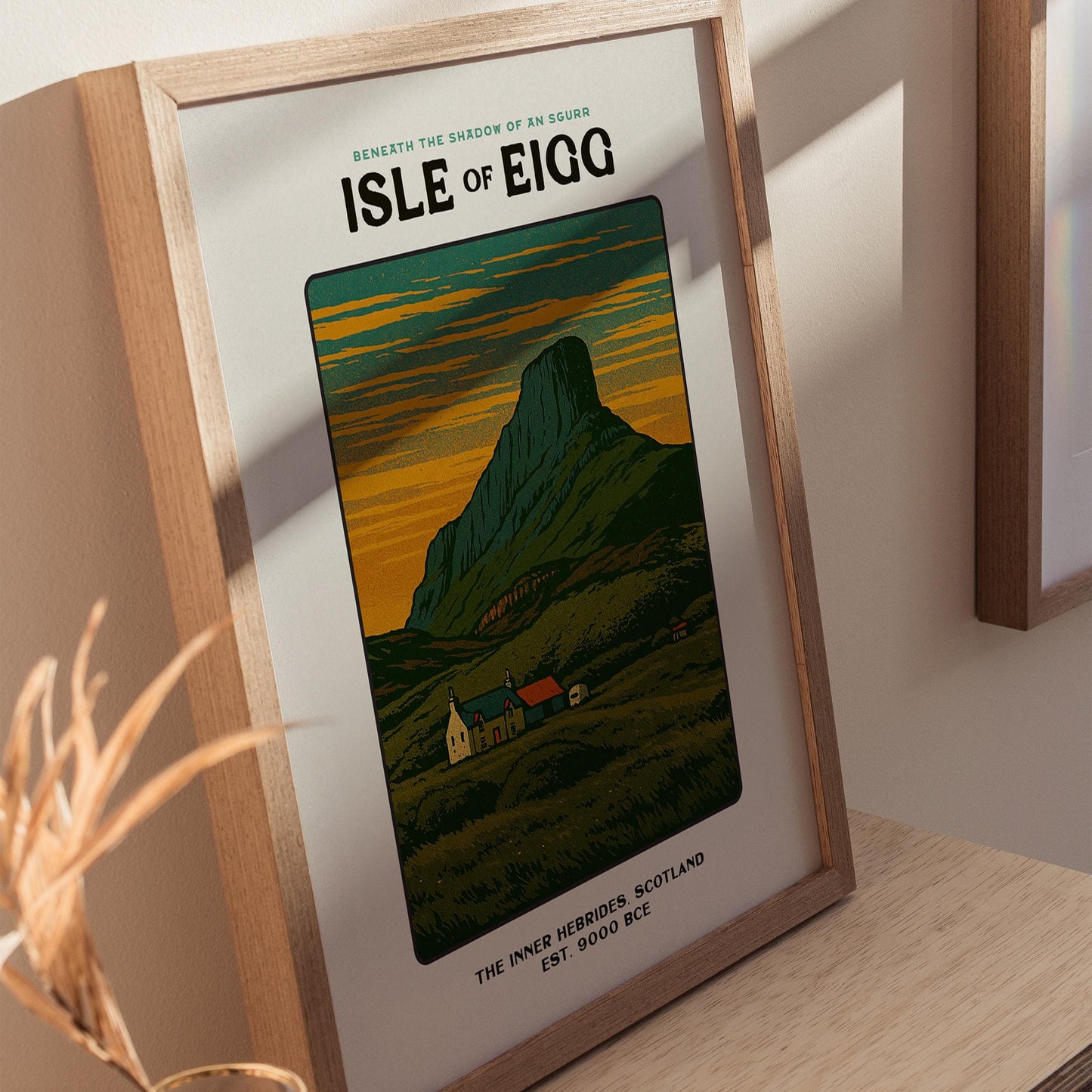 Natural wood frame Isle of Eigg vintage poster styled with travel books and plants