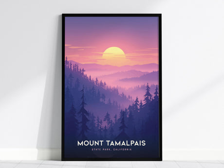 A framed poster of Mount Tamalpais State Park features a vibrant California sunset with shades of pink and purple, silhouetted trees, and rolling hills. The artwork is propped against a white wall.