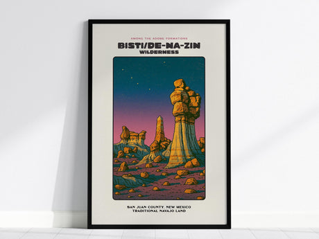 A framed poster depicting the Bisti/De-Na-Zin Wilderness with vibrant rock formations under a starry sky. The artwork features desert hues and is labeled with San Juan County, New Mexico. Ideal wall art for nature enthusiasts.