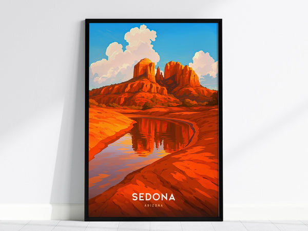 A framed poster features a vibrant illustration of Sedonas iconic red rock formations reflected in a serene river, under a bright blue sky with fluffy clouds. The bottom of the poster reads Sedona Arizona.