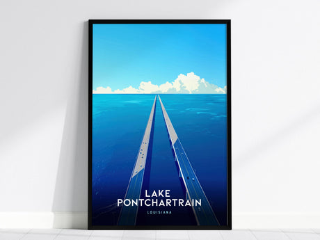 A framed poster depicts a stylized view of Lake Pontchartrain with a long, straight bridge extending into the distance under a bright blue sky with clouds. The text Lake Pontchartrain, Louisiana is at the bottom.