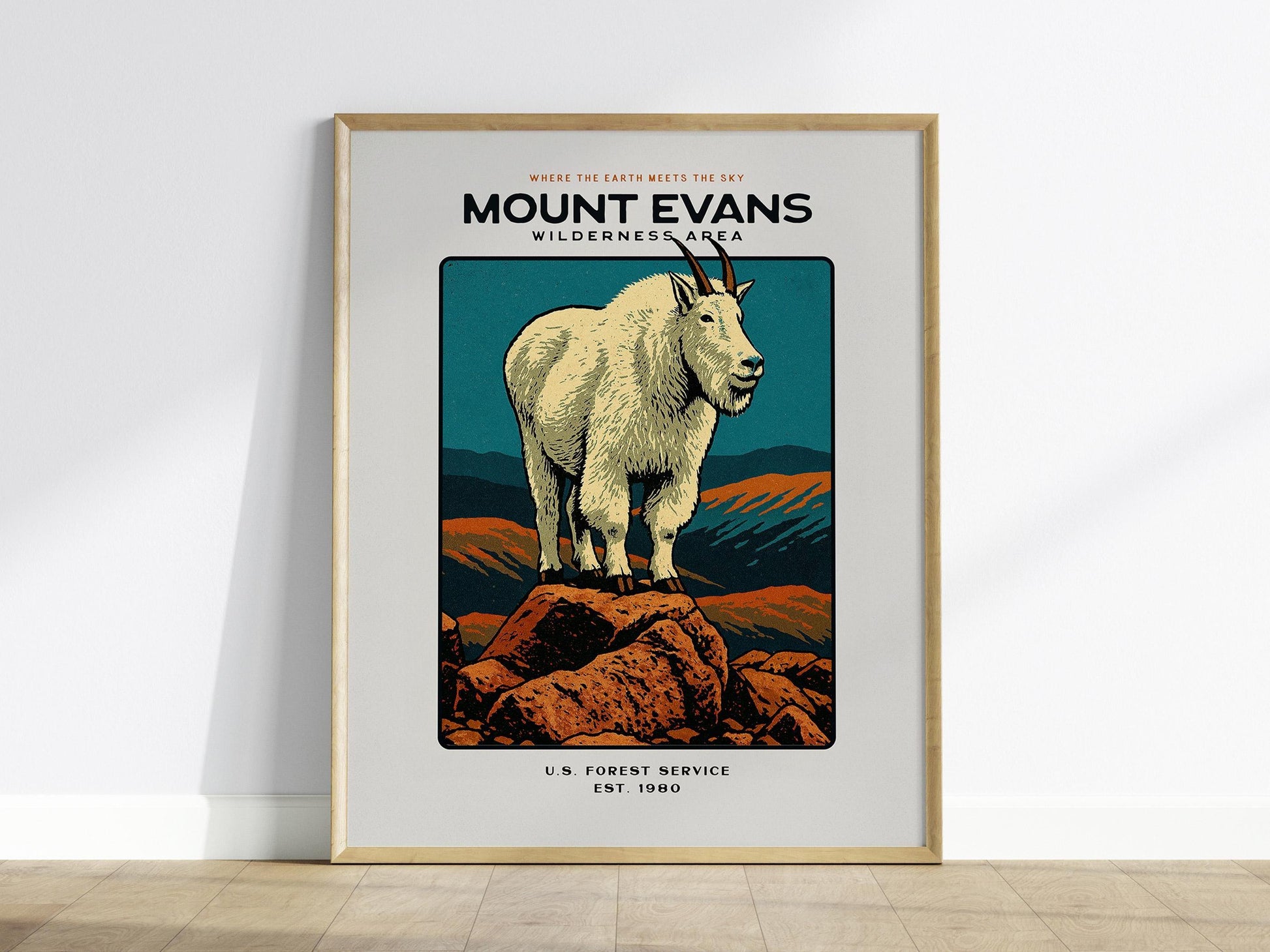 Framed poster of a mountain goat on Mount Evans with a wooden frame.