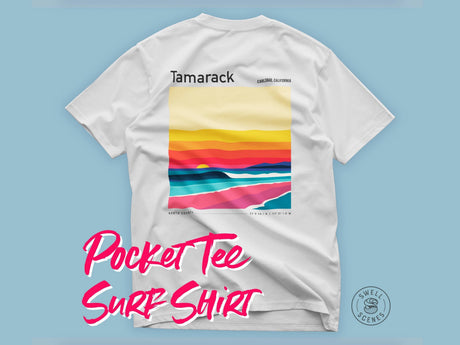 White Tamarack surf spot t-shirt with colorful graphic and text on a light blue background