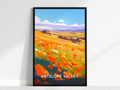 Framed poster depicting a vibrant field of orange poppies in Antelope Valley, California, under a bright blue sky with fluffy clouds. The rolling hills in the background enhance the colorful landscape.