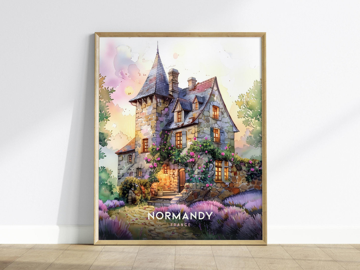 Framed artwork of a picturesque house with 'Normandy, France' text on a white wall.