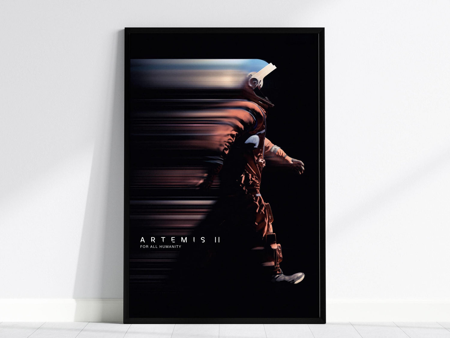 Black framed Artemis II NASA poster centered over a sofa with minimalist home decor