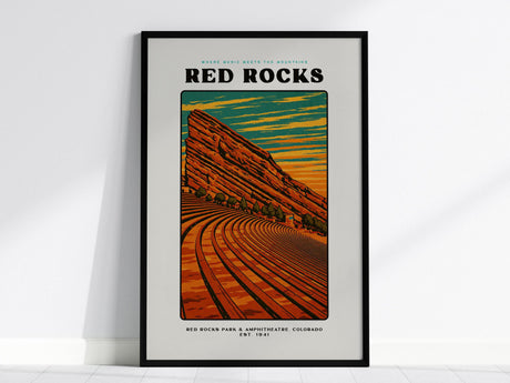 Framed poster of Red Rocks Amphitheatre featuring a vintage block print design. The artwork showcases curved seating against vibrant orange and blue skies, with bold typography and Red Rocks prominently displayed at the top.