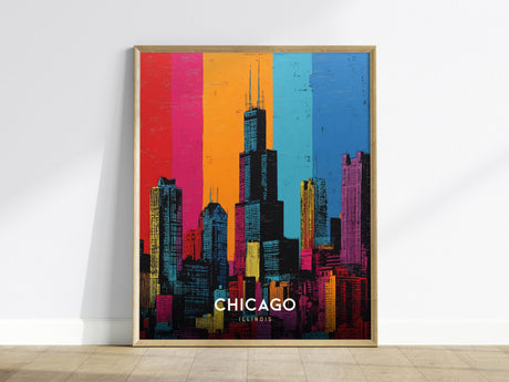 A framed pop art poster of the Chicago skyline in vibrant colors, featuring the iconic Willis Tower. The background is divided into vertical bands of red, orange, blue, and pink, enhancing the cityscapes modern and artistic appeal.