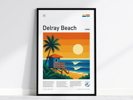 A framed poster of Delray Beach features a vibrant illustration of a lifeguard tower, a silhouetted palm tree, and a radiant sunrise over the ocean. The artwork is set against bold orange and blue hues, capturing a tropical coastal scene.