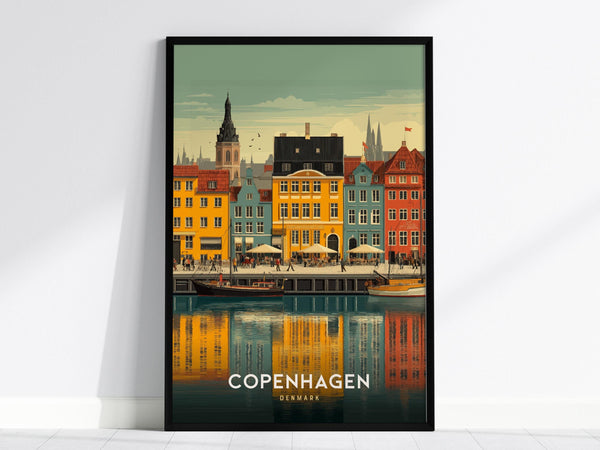 A framed poster of Copenhagens Nyhavn Harbor features colorful buildings and sailboats reflecting in the water. The lively scene captures the charm of the iconic canal area with a clear sky above.
