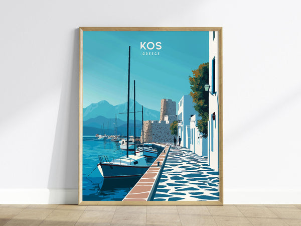 A framed poster of Kos, Greece, features a serene harbor scene with sailboats, whitewashed buildings, and a stone pathway. The backdrop includes a medieval castle and distant mountains under a clear blue sky.