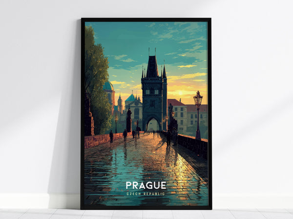 A framed poster of Pragues Charles Bridge at sunset, showcasing the iconic medieval architecture with a golden sky in the background. Silhouetted figures walk along the reflective cobblestone path.