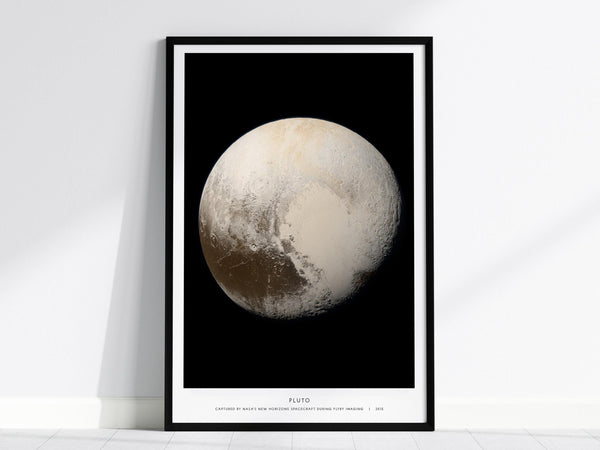 Framed poster of Pluto on a white wall