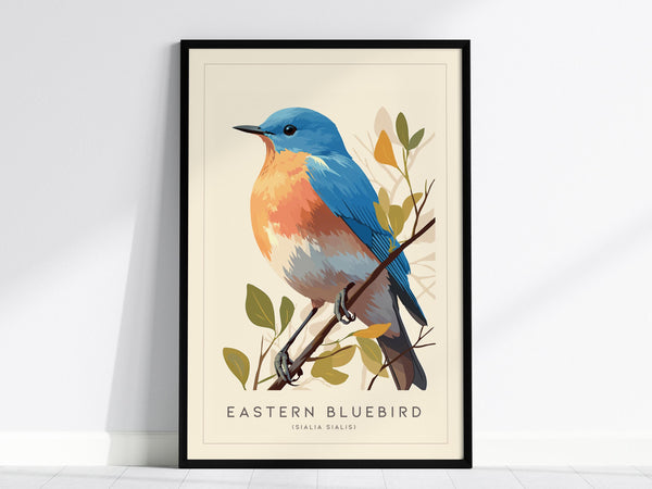 Illustrated print of an Eastern Bluebird with vibrant sky-blue wings and an orange breast, perched on a branch with green leaves. The artwork is displayed in a black frame against a light wall.