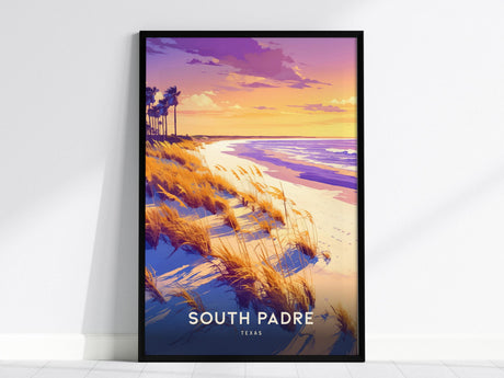 Framed poster depicting a vibrant South Padre Island sunset with golden hues over the beach and ocean. Tall grasses and palm trees accentuate the coastal scene, with South Padre Texas text at the bottom.