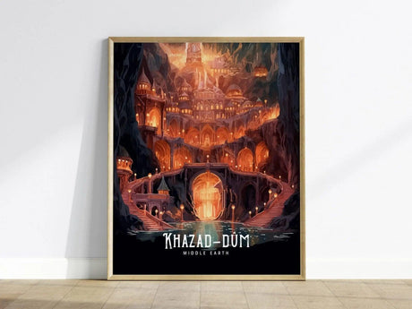 Framed poster depicting a majestic, torchlit city with grand arches and intricate stone structures, labeled Khazad-Dum Middle Earth, against a white wall.