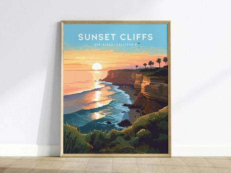A framed poster titled Sunset Cliffs, San Diego, California depicts a vibrant sunset over the ocean, with golden hues reflecting on the water.