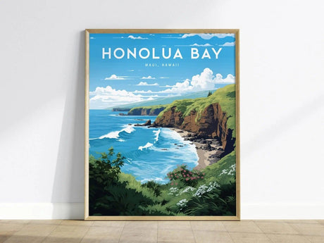 Framed poster of Honolua Bay, Maui, featuring vibrant blue waves, lush green cliffs, and a clear sky with clouds, leaning against a white wall on a wooden floor.