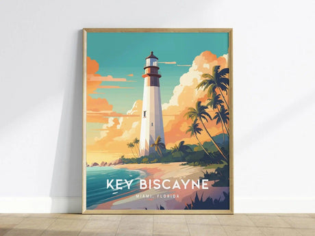 A framed poster features the iconic Key Biscayne Lighthouse against a colorful sunset sky. The illustration showcases swaying palm trees and a sandy beach, with the text KEY BISCAYNE, MIAMI, FLORIDA prominently displayed at the bottom.