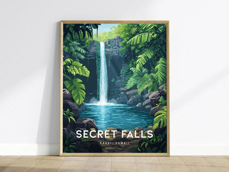 A framed poster depicting a waterfall cascading into a clear pool, surrounded by lush green tropical foliage and rocks. The text SECRET FALLS KAUAI HAWAII is at the bottom.