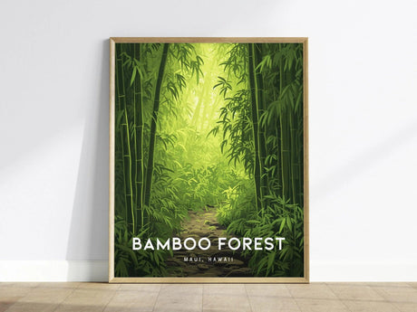 A framed poster features a lush bamboo forest with a sunlit path, titled Bamboo Forest Maui, Hawaii, leaning against a white wall on a wooden floor.