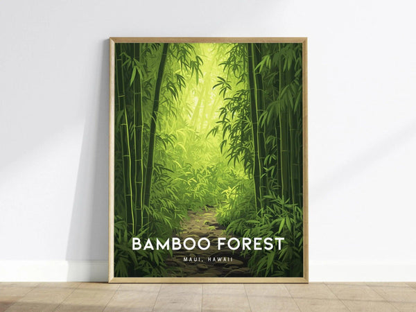 A framed poster features a lush bamboo forest with a sunlit path, titled Bamboo Forest Maui, Hawaii, leaning against a white wall on a wooden floor.