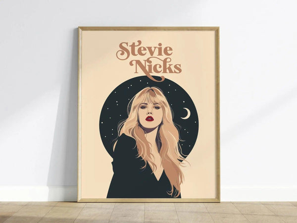 A framed poster features an illustrated portrait of a woman with long blonde hair and red lips against a dark circular background with stars and a crescent moon.