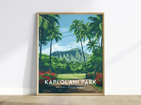 A framed poster of Kapiolani Park features lush green palm trees and vibrant red flowers with a scenic mountain backdrop under a blue sky.