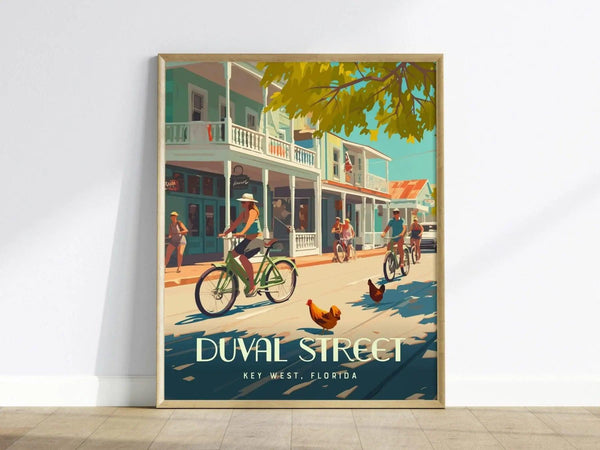 A vibrant poster of Duval Street in Key West depicts cyclists, pedestrians, and roosters under sunny skies, framed against colorful buildings. Text reads Duval Street, Key West, Florida.