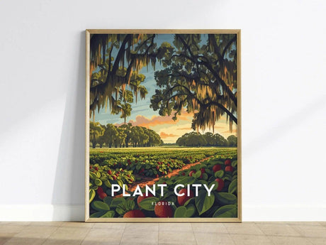 A beautifully framed poster of Plant City, Florida, depicting a vibrant sunset over lush strawberry fields, with towering oak trees draped in Spanish moss. The artwork captures the serene beauty and charm of Floridas agricultural landscape.