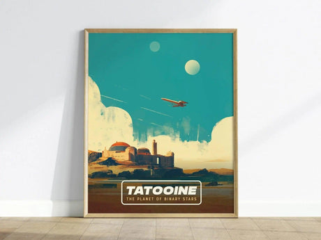 A framed poster of Tatooine, showcasing a stylized desert landscape with two moons in a bright blue sky. The artwork features an iconic structure with a vintage travel poster aesthetic, labeled TATOOINE - THE PLANET OF BINARY STARS.