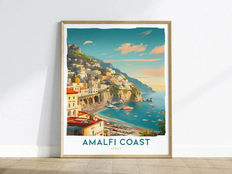 A vibrant travel print depicting the Amalfi Coast in Italy, featuring colorful pastel villages perched on steep cliffs above a serene turquoise sea. The artwork is framed and includes the text AMALFI COAST and ITALY at the bottom.