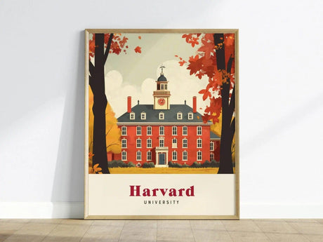 A framed poster of Harvard University depicts a large, red-brick building with a clock tower, surrounded by vibrant autumn foliage. The artwork features a warm color palette and the text Harvard University prominently at the bottom.